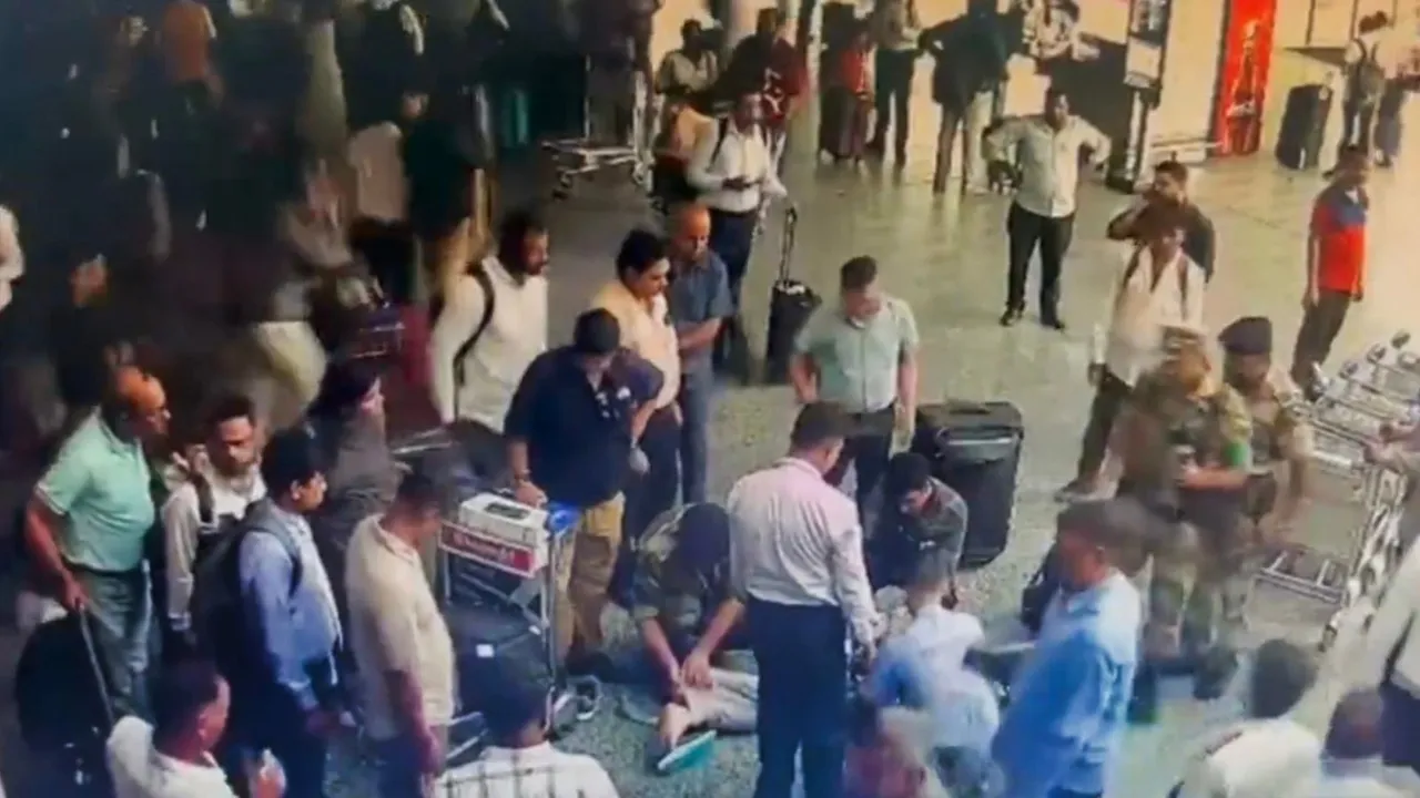 CISF personnel give CPR to a passenger who fainted at IGI Airport, in New Delhi, Thursday, Aug. 22, 2024.
