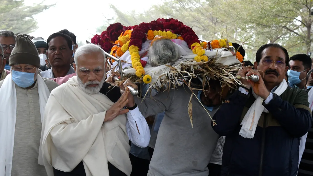 PM Modi carries mortal remains of his mother Heeraben Modi during her funeral procession, in Gandhinagar