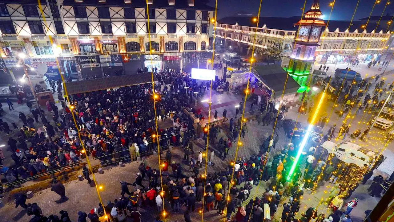 People gather at the clock tower Lal Chowk to attend a musical show to celebrate the new year 2024, in Srinagar, Sunday, Dec. 31, 2023.