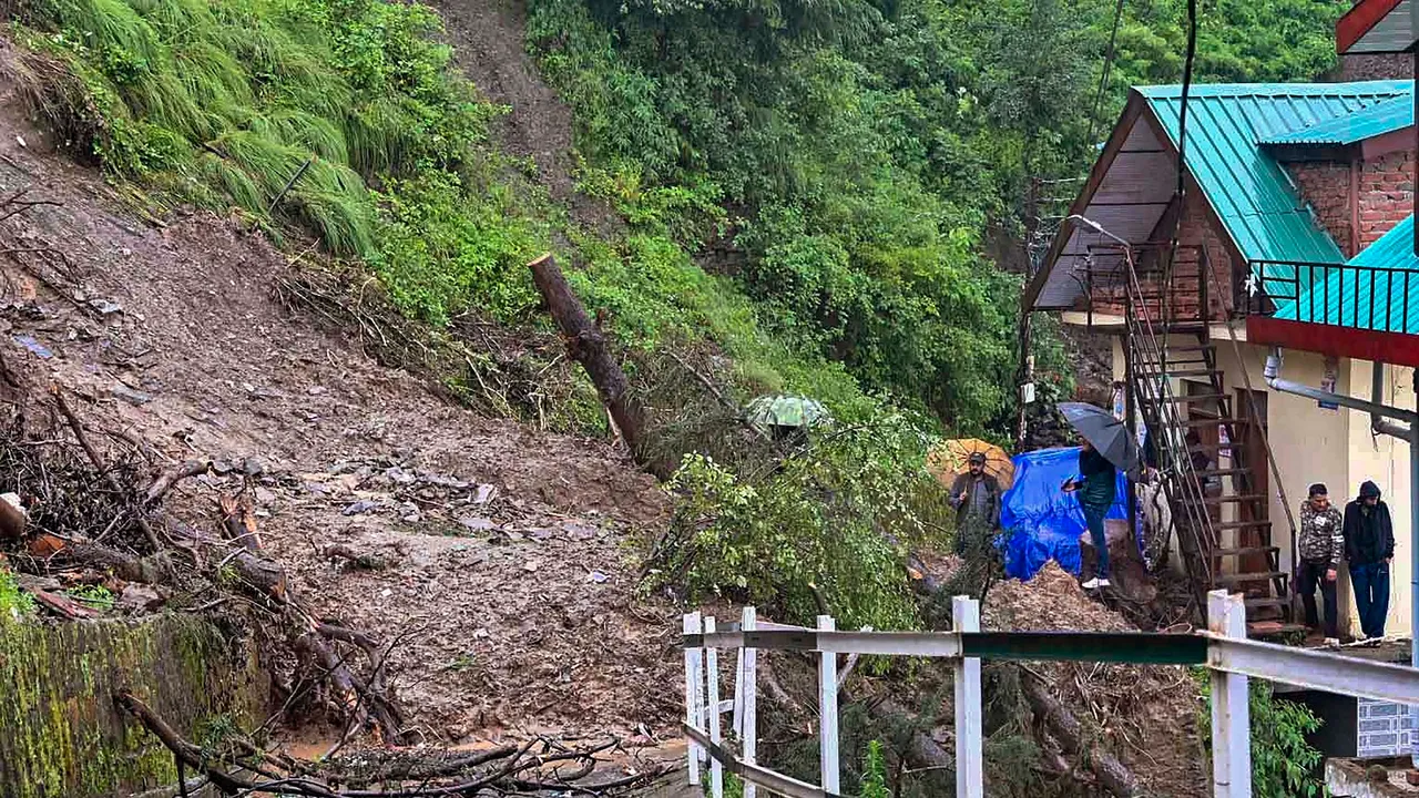 Debris on a road after landslide near a residential colony following monsoon rainfall, at Sanjauli in Shimla