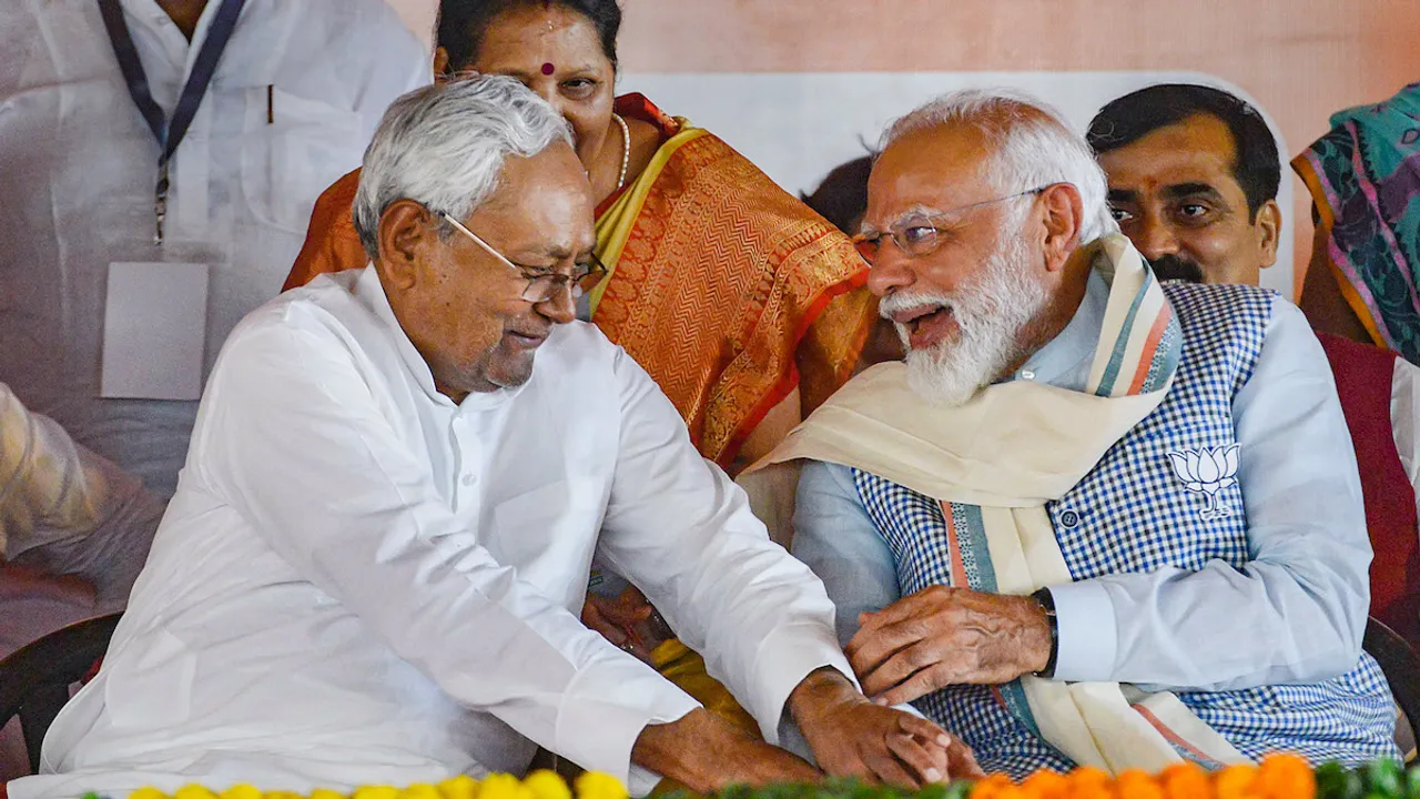 Bihar chief minister Nitish Kumar sharing a ligher moment with Prime Minister Narendra Modi which was termed as touching feet