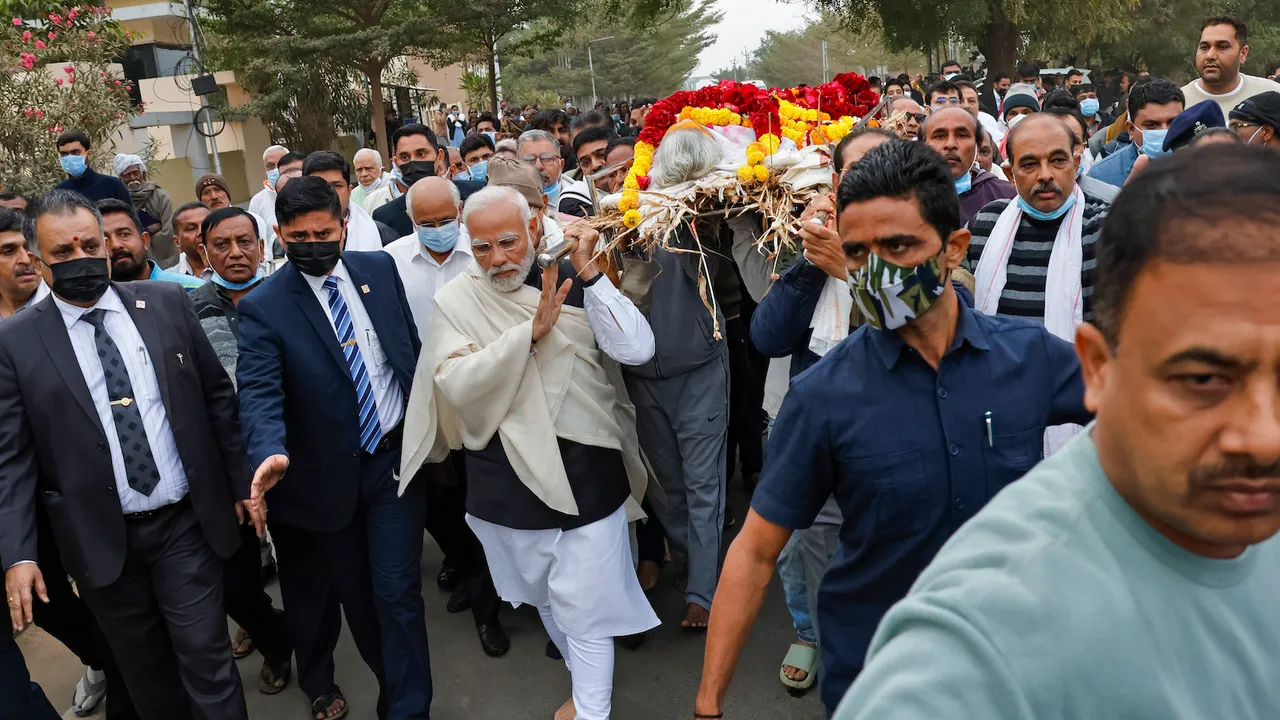 Prime Minister Narendra Modi carries mortal remains of his mother Heeraben Modi