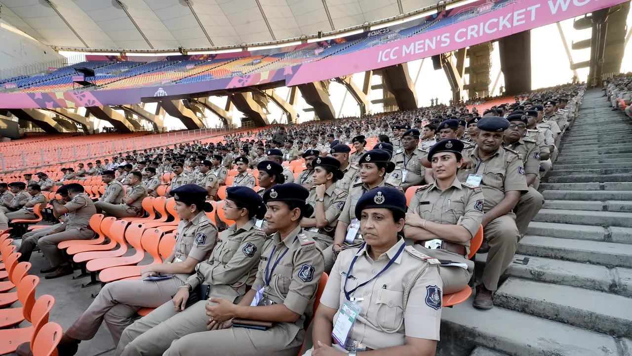 Police personnel wait for their duty orders ahead of the 2023 ICC Men's Cricket World Cup at the Narendra Modi Stadium, in Ahmedabad