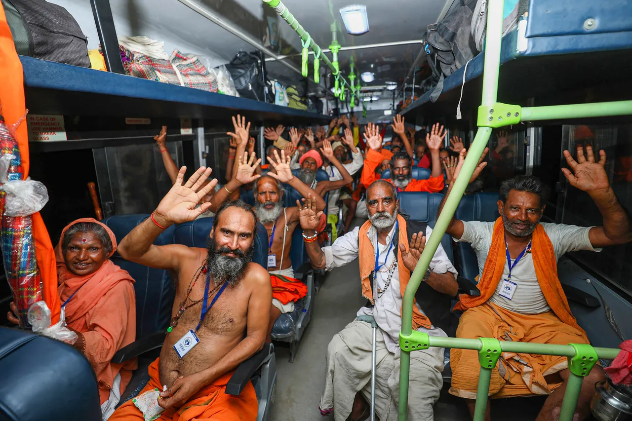 Pilgrims raise religious slogans after boarding a bus as they leave for the Amarnath Yatra 2023, in Jammu