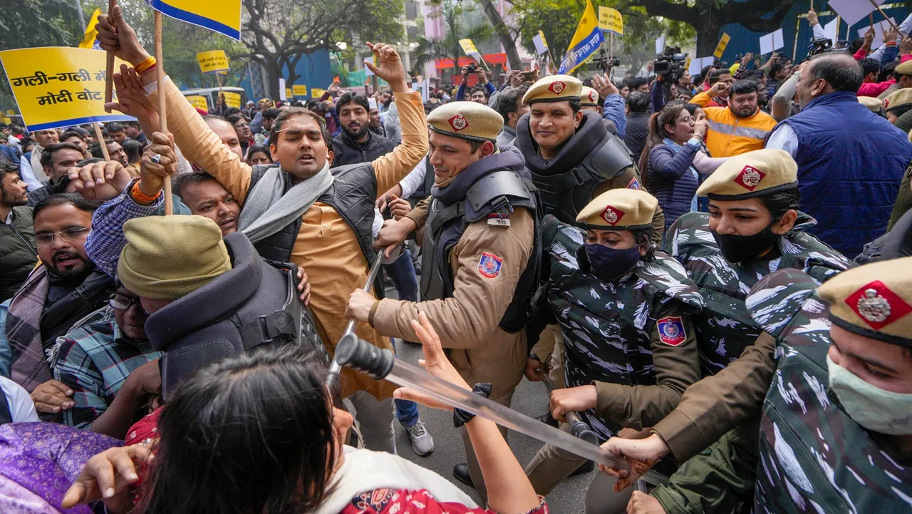 Police personnel stop AAP supporters during a protest, in New Delhi