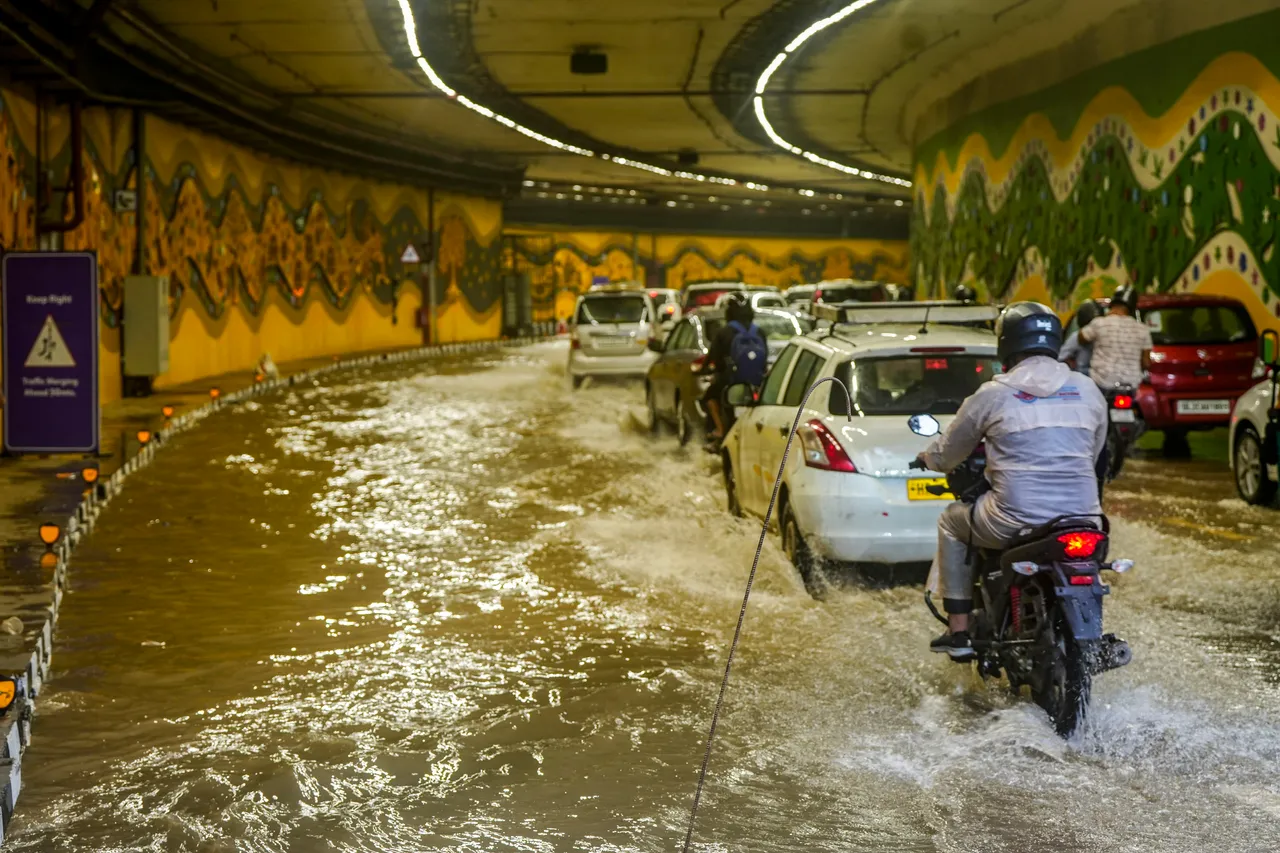 Vehicles pass through a waterlogged tunnel amid heavy monsoon rains, near Pragati Maidan in New Delhi
