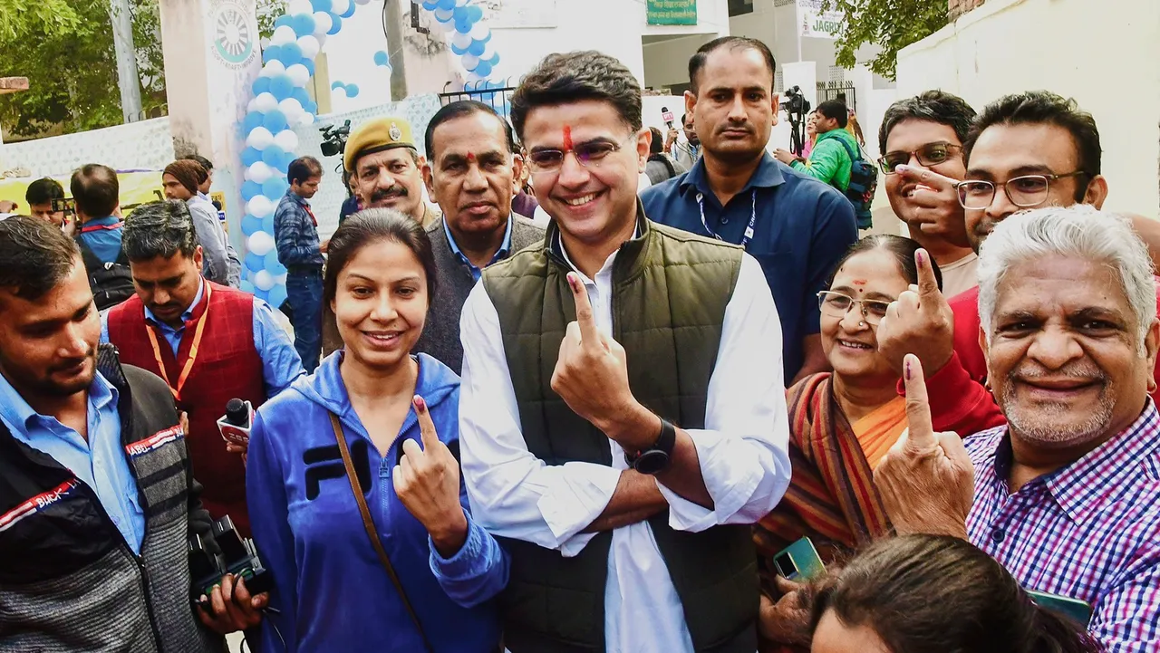 Congress leader Sachin Pilot and other voters show their fingers marked with indelible ink after casting their votes during Rajasthan Assembly elections