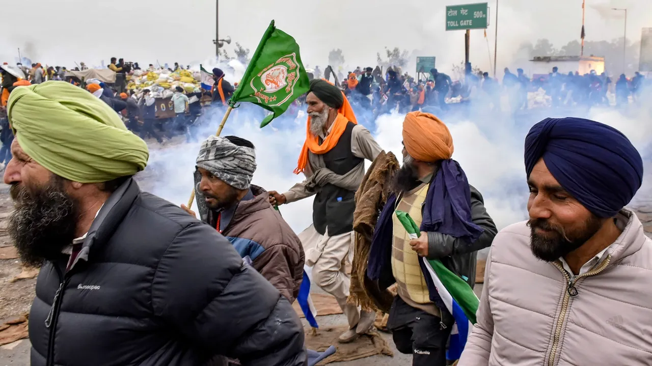 Protesting farmers disperse after a tear gas firing during their 'Delhi Chalo' march, near the Punjab-Haryana Shambhu Border, in Patiala district