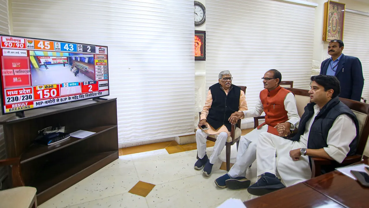 Madhya Pradesh Chief Minister Shivraj Singh Chouhan with Union Minister Jyotiraditya Scinda watches a live telecast of election results during counting of votes for MP Assembly elections, in Bhopal