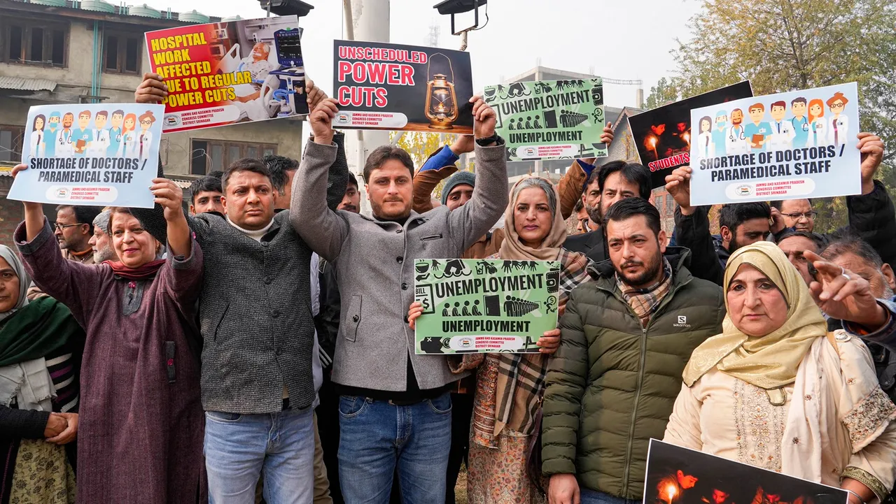 Congress leaders and workers raise slogans during a protest over unscheduled power cuts, in Srinagar
