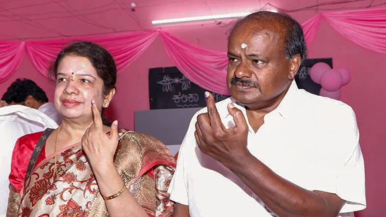 NDA candidate H D Kumaraswamy and his wife Anitha shows their inked fingers after casting their votes for the 2nd phase of Lok Sabha elections, in Ramnagara, Friday, April 26, 2024