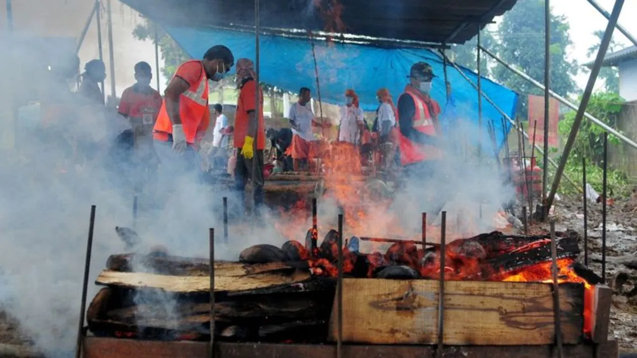 People cremate victims of the landslides at a cremation ground in Meppadi village in Wayanad district