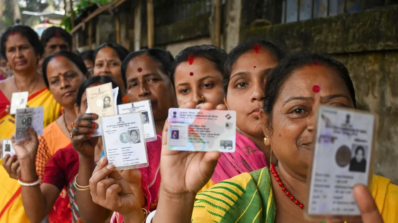 Voters show their identification cards as they wait in a queue at a polling station to cast their votes for the first phase of Lok Sabha�elections, in Agartala, Friday, April 19, 2024