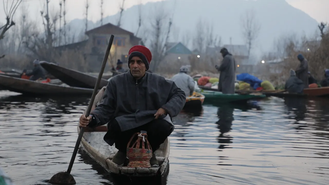 Boat man with kangri kashmir lake.jpeg