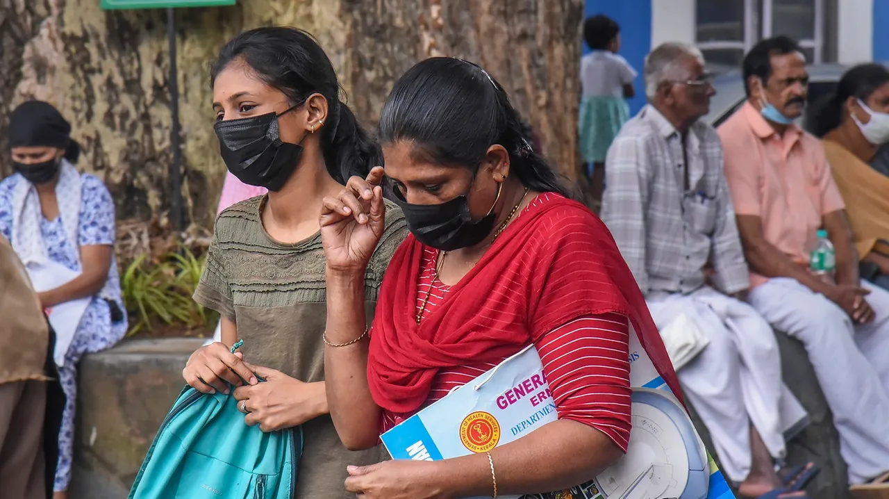 Visitors wear masks at the Ernakulam Government Hospital after rise in number of COVID cases, in Kochi
