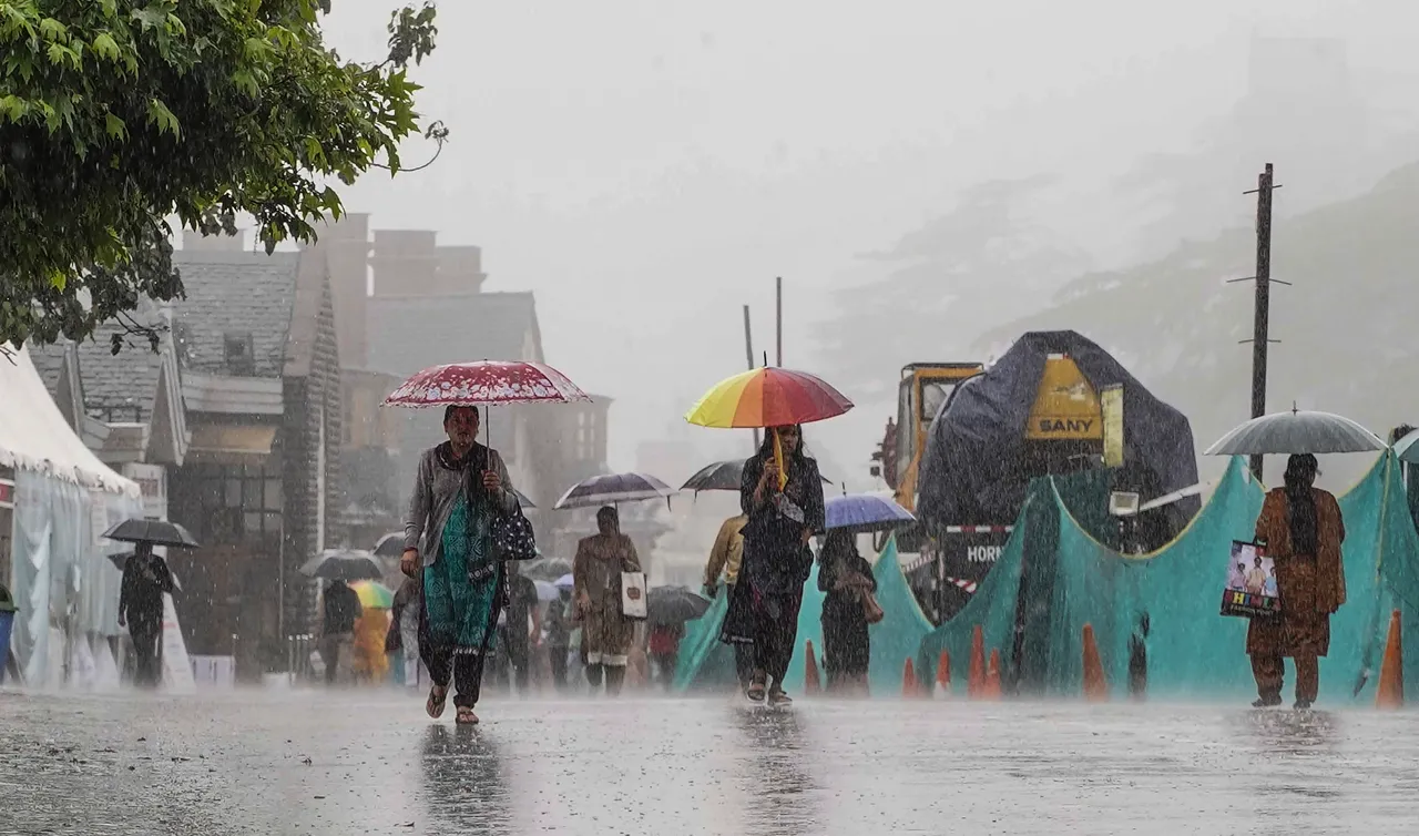Pedestrians during monsoon rain, in Shimla