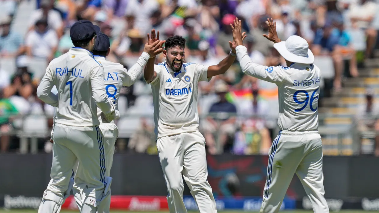 Mohammed Siraj celebrates a wicket with teammates on the first day of the second Test cricket match