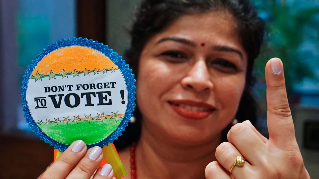 A school teacher poses for photos as part of the voter awareness campaign on the eve of the 2nd phase of Lok Sabha elections, in Thane, Friday, April 26, 2024