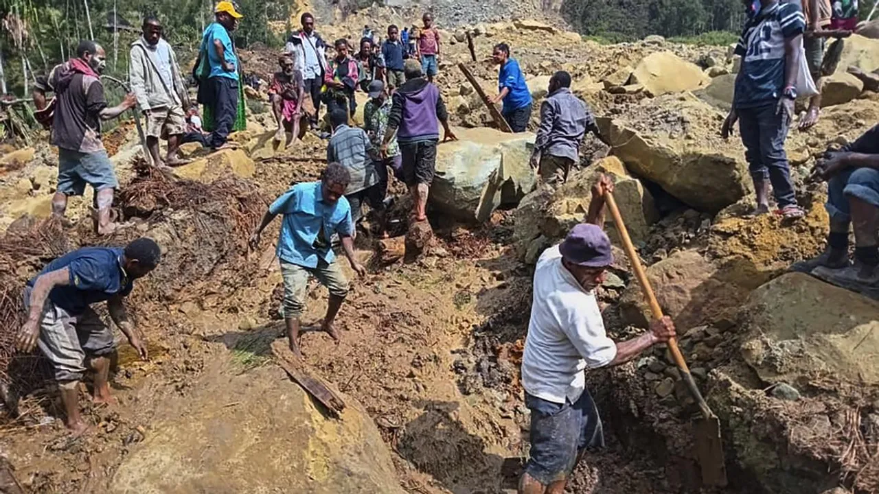 Villagers search through a landslide in Pogera village, in the Highlands of Papua New Guinea on May 26, 2024