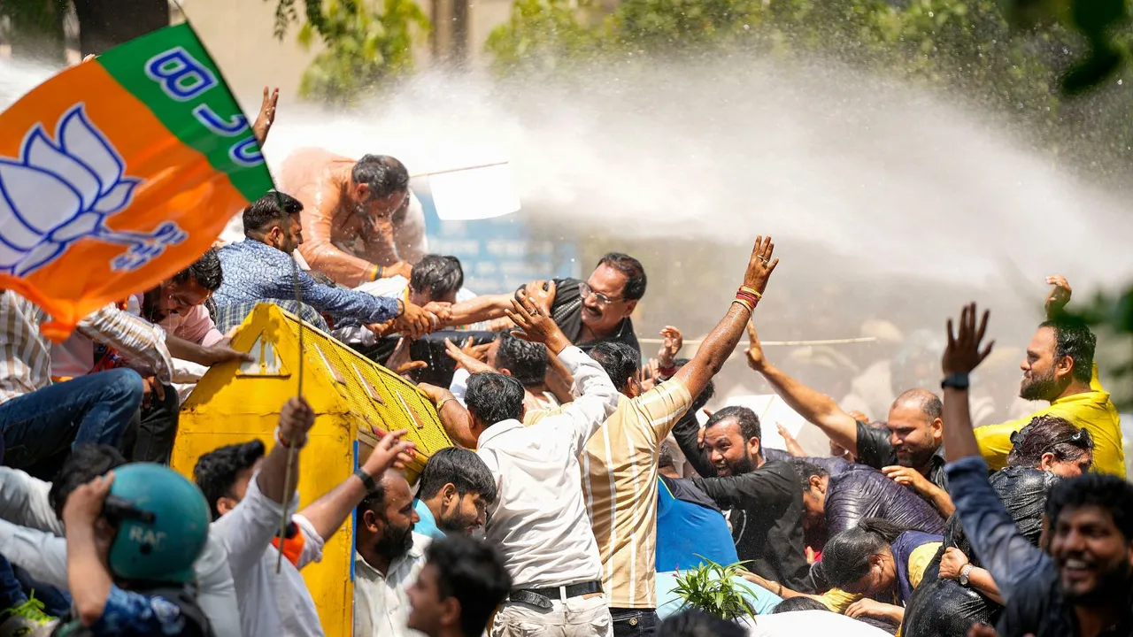 Security personnel use water cannon to disperse BJP workers protesting against AAP convener and Delhi CM Arvind Kejriwal, outside AAP office in New Delhi, Wednesday, April 10, 2024