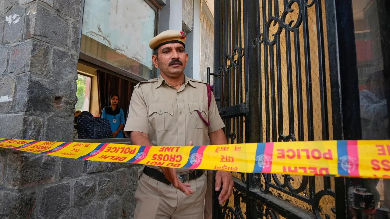 A police personnel exits the Mother Mary's School, Mayur Vihar after multiple schools received bomb threats via e-mail, in New Delhi, Wednesday, May 1, 2024