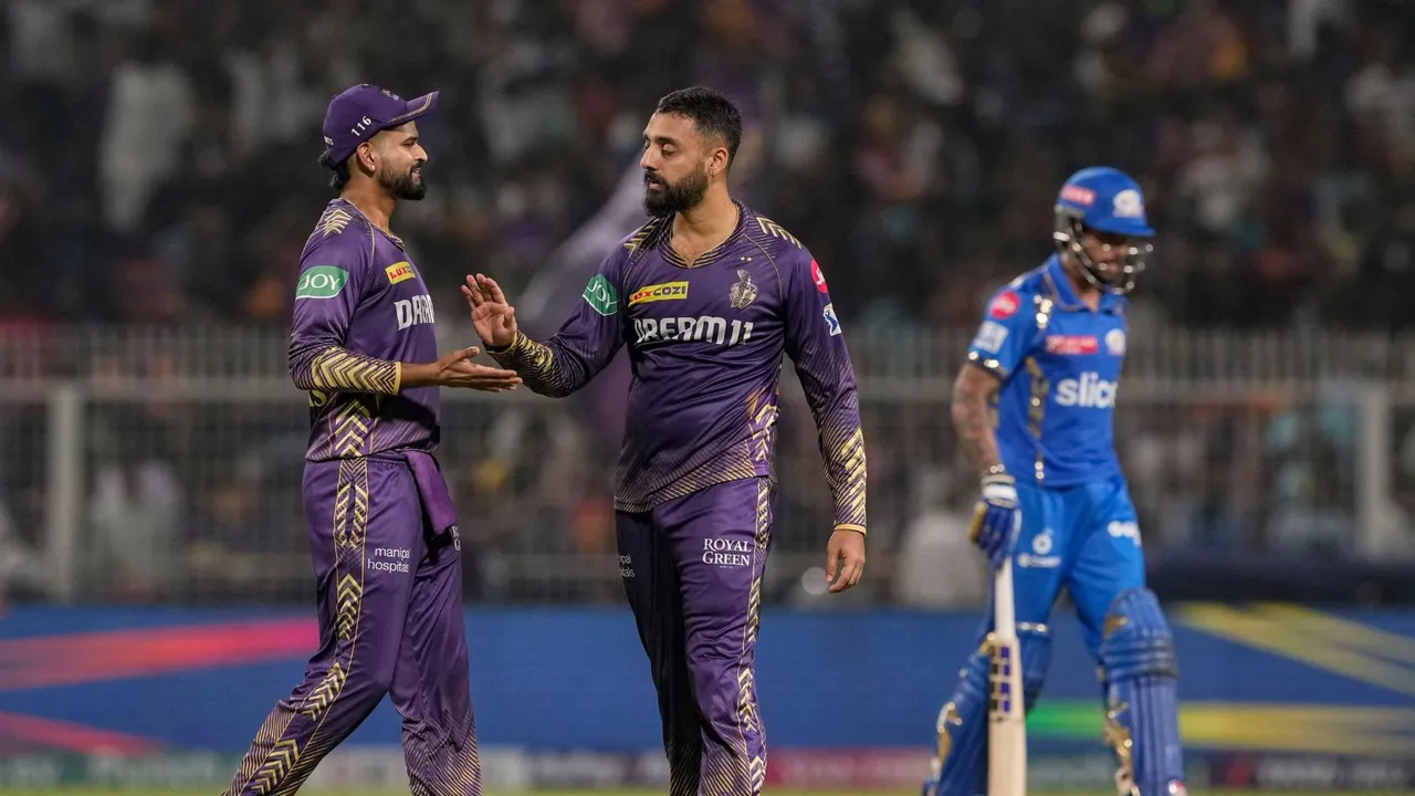 Kolkata Knight Riders' Varun Chakravarthy celebrates with captain Shreyas Iyer after taking the wicket of Mumbai Indians' captain Hardik Pandya during an Indian Premier League (IPL) 2024 T20 cricket match