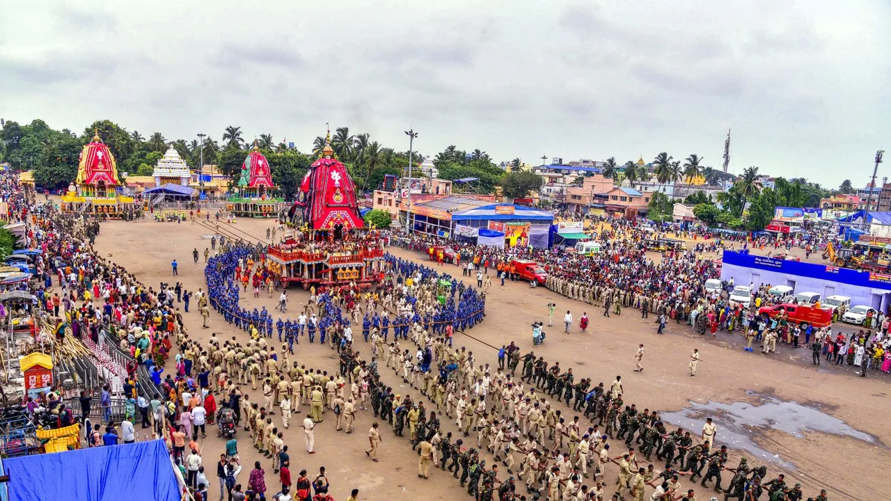 Policemen pull a chariot during preparations for the 'Bahuda Yatra', the return journey of Lord Jagannath, as part of the annual Rath Yatra festival, in Puri, Friday, July 12, 2024.