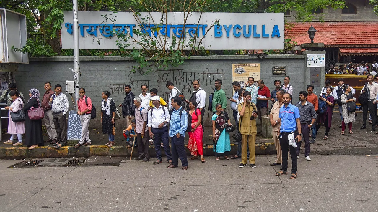 Commuters wait in a long queue for buses at a stop during a strike by drivers of private bus operators hired by Brihanmumbai Electric Supply and Transport (BEST), in Mumbai