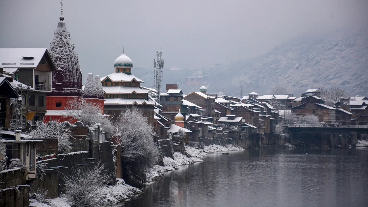 Buildings along the Jhelum river covered in snow after snowfall, in Srinagar
