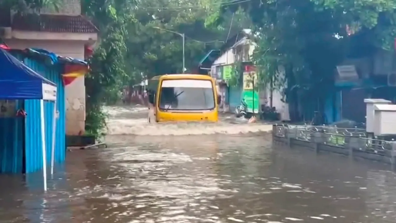 A bus moves on a flooded road following heavy rainfall, near Andheri Subway in Mumbai, Monday, July 8, 2024.