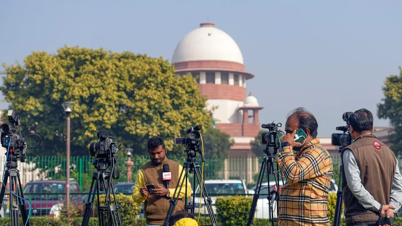Media persons at the Supreme Court complex on the day of the court's verdict on a batch of petitions challenging the abrogation of Article 370 of the Constitution