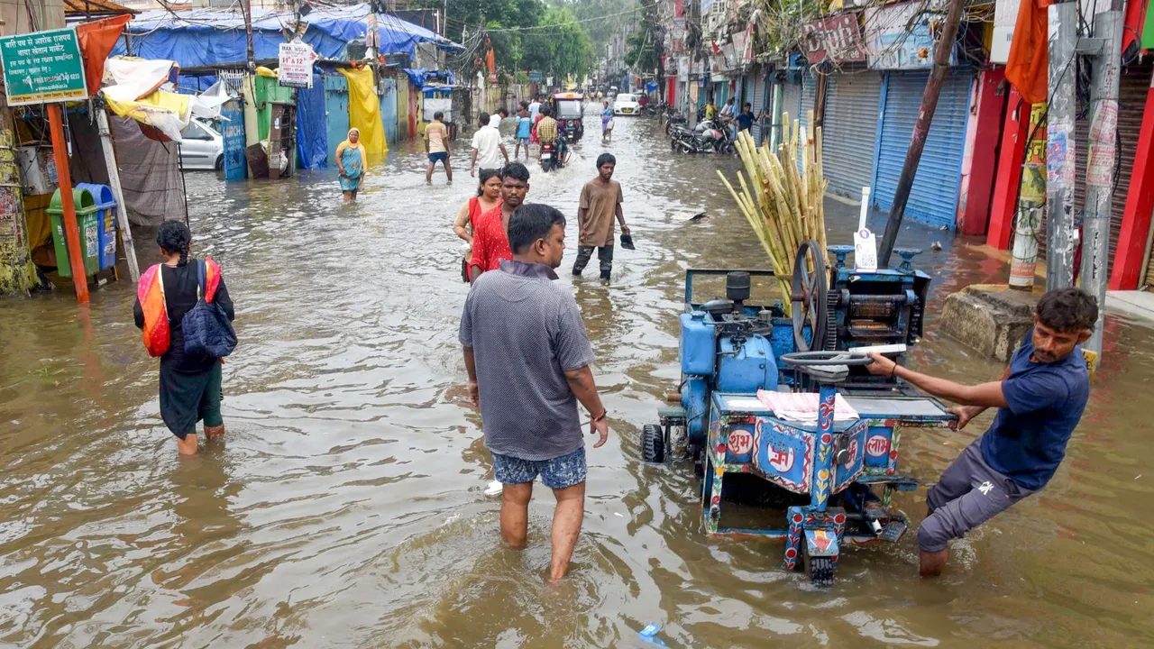 Commuters wade through a waterlogged road following rains, in Patna, Sunday, July 7, 2024.