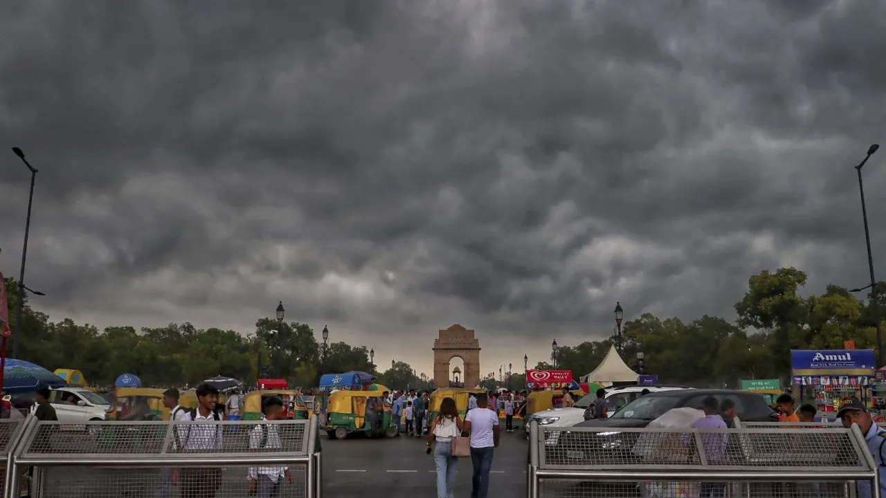 Dark clouds hover in the sky above the India Gate