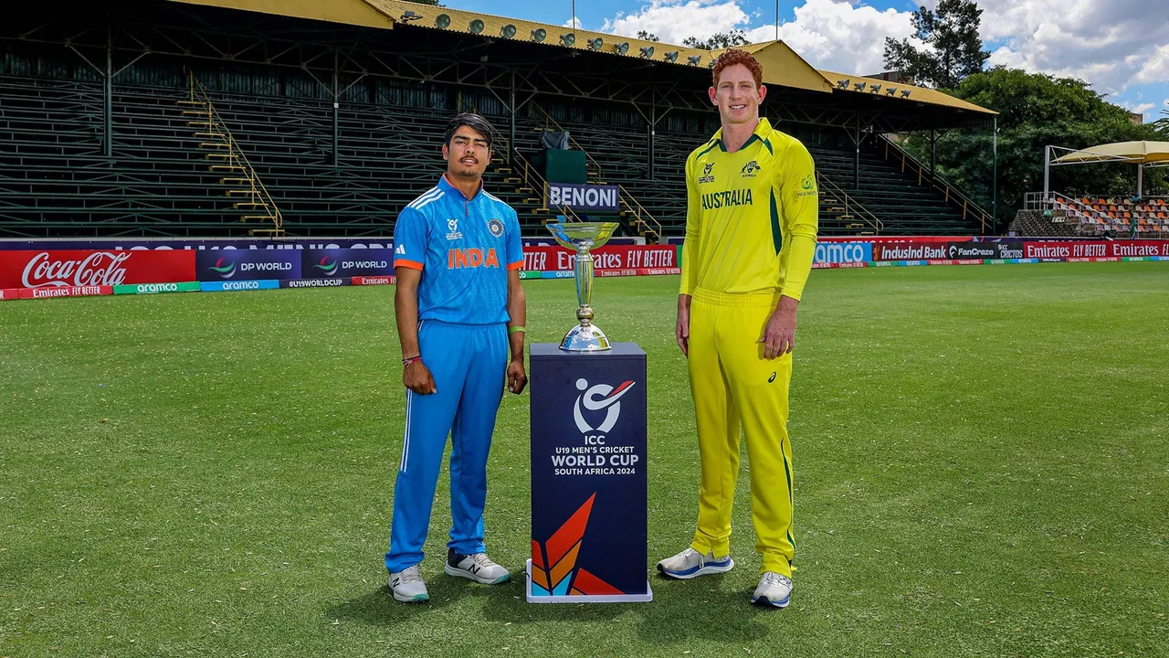 Indian captain Uday Saharan and Australian captain Hugh Weibgen pose with the trophy ahead of the ICC Under-19 Men's Cricket World Cup final, in South Africa