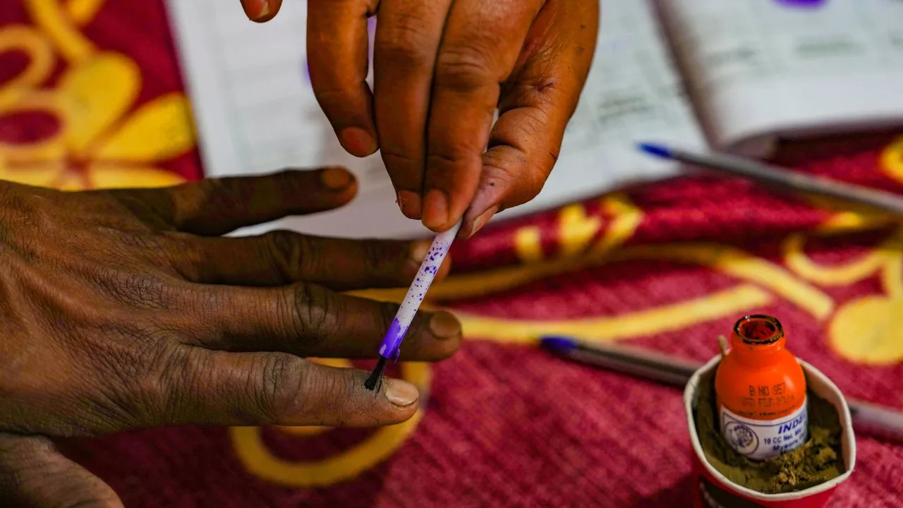 A voter's finger being marked with indelible ink by a polling official during voting for the 3rd phase of Lok Sabha elections, in Bareilly, Tuesday, May 7, 2024