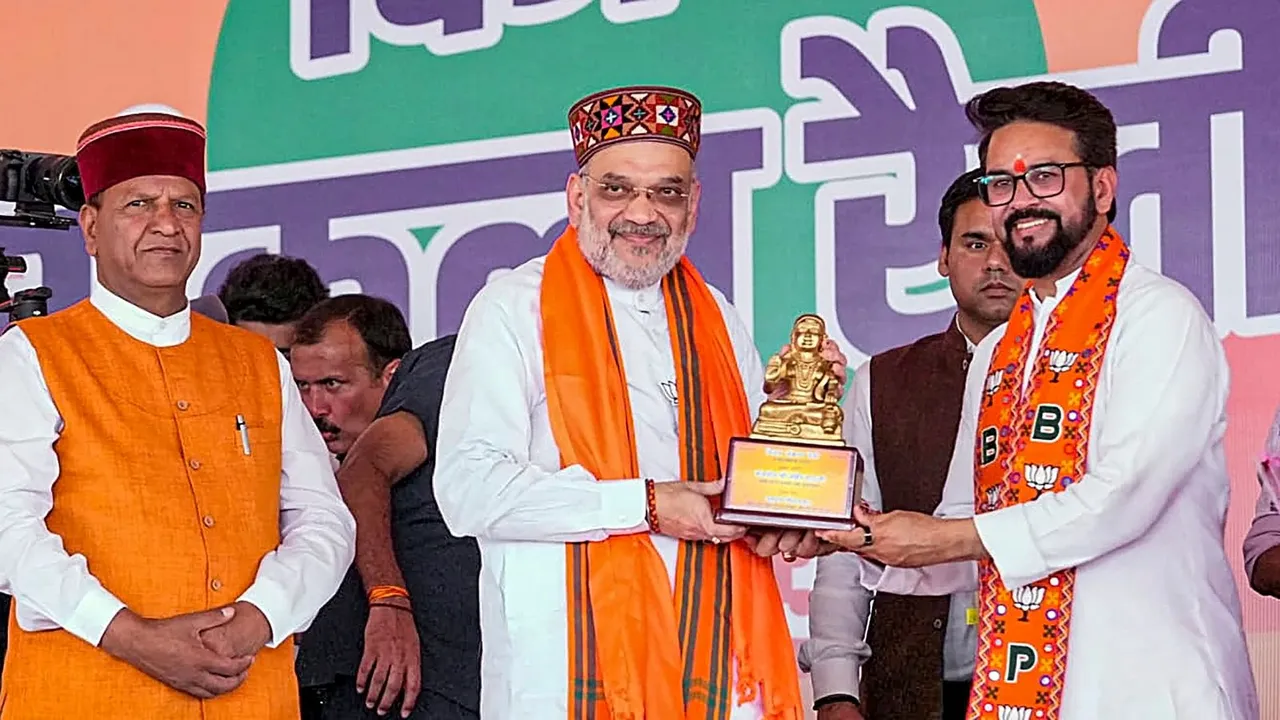 Union Home Minister and BJP leader Amit Shah being felicitated by BJP candidate from Hamirpur Lok Sabha constituency Anurag Thakur during a campaign rally for Lok Sabha polls, in Una, Saturday, May 25, 2024