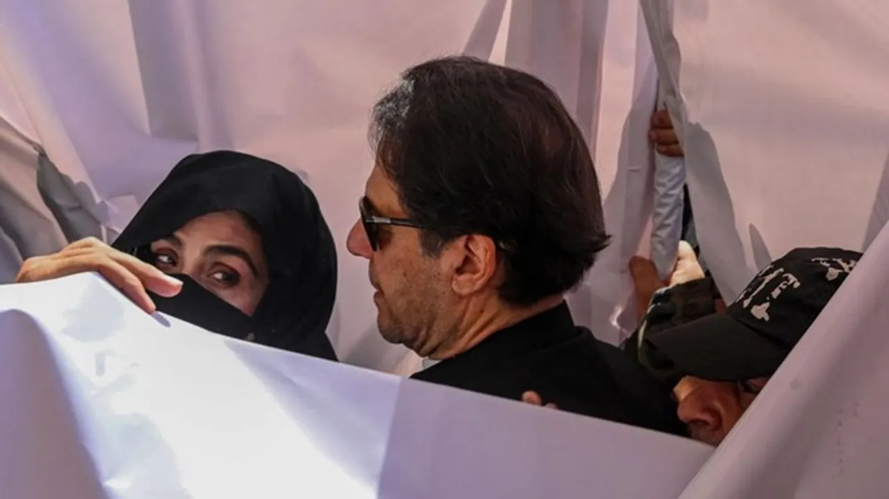 Former Pakistan Prime Minister Imran Khan (C) with his wife Bushra Bibi (L) arrive to appear at a high court in Lahore on May 15, 2023.