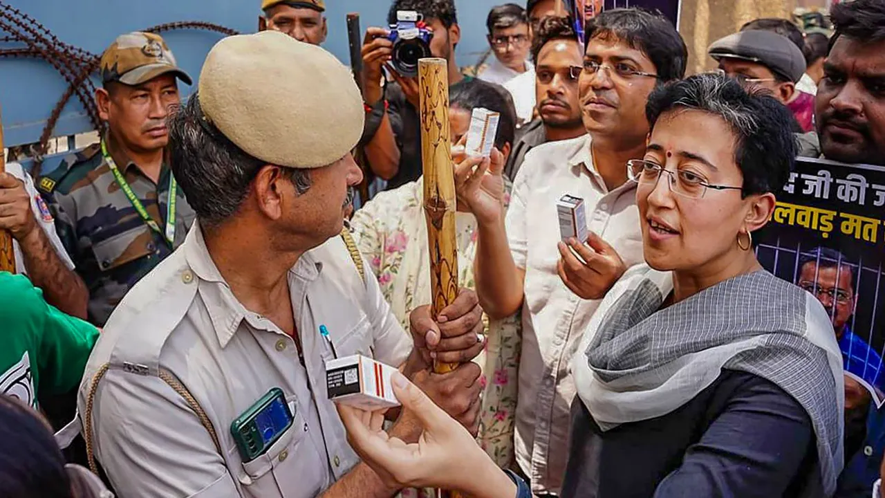 Delhi Minister Atishi along with AAP supporters carries 'insulin' during a protest over Tihar administration's alleged failure in providing insulin to jailed Delhi CM Arvind Kejriwal, outside the Tihar jail, in New Delhi, Sunday, April 21, 2024.