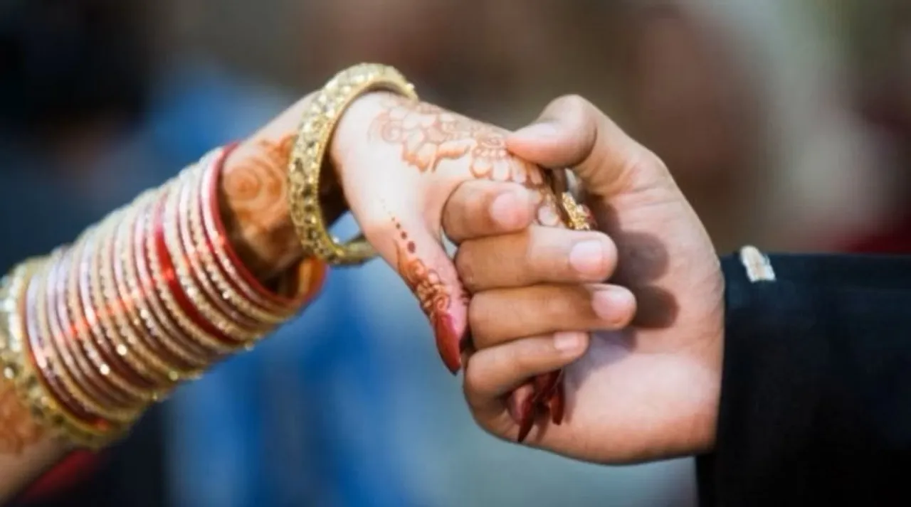 Man and woman holding hands, getting married