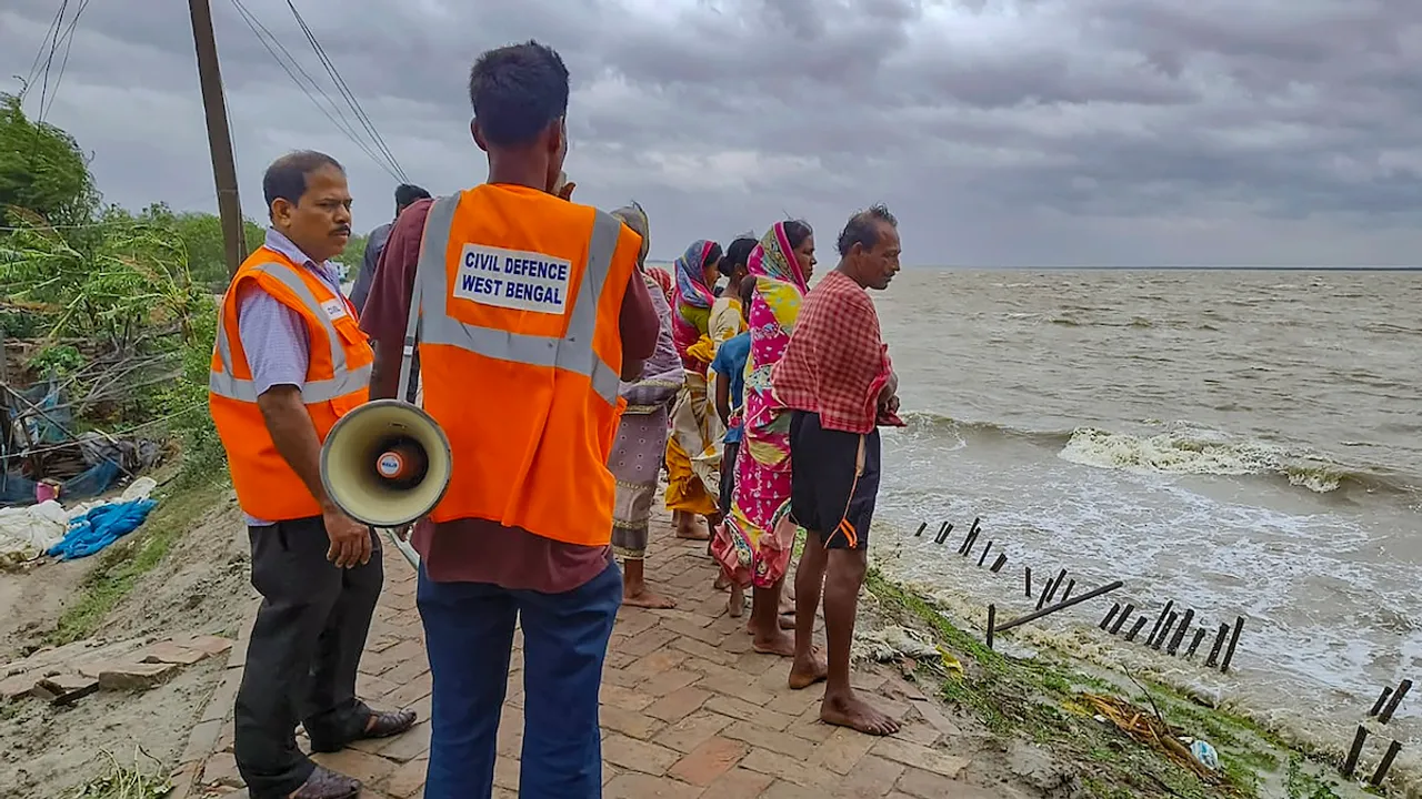 NDRF and Block Disaster Management personnel make announcements as part of precautionary measures, ahead of the landfall of Cyclone 'Remal', in South 24 Parganas district, Sunday, May 26, 2024.