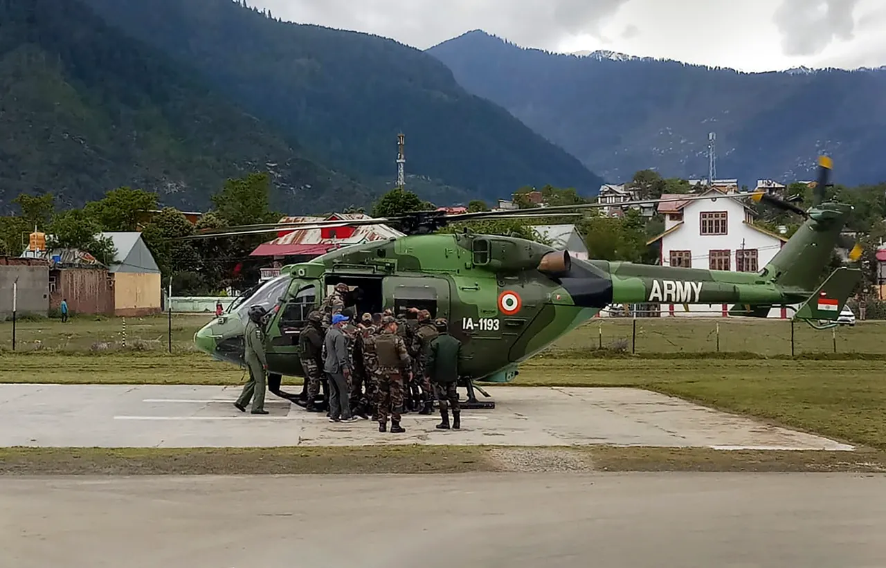 Indian Army personnel launch a rescue operation after an Army helicopter crashed in Jammu and Kashmir's Kishtwar