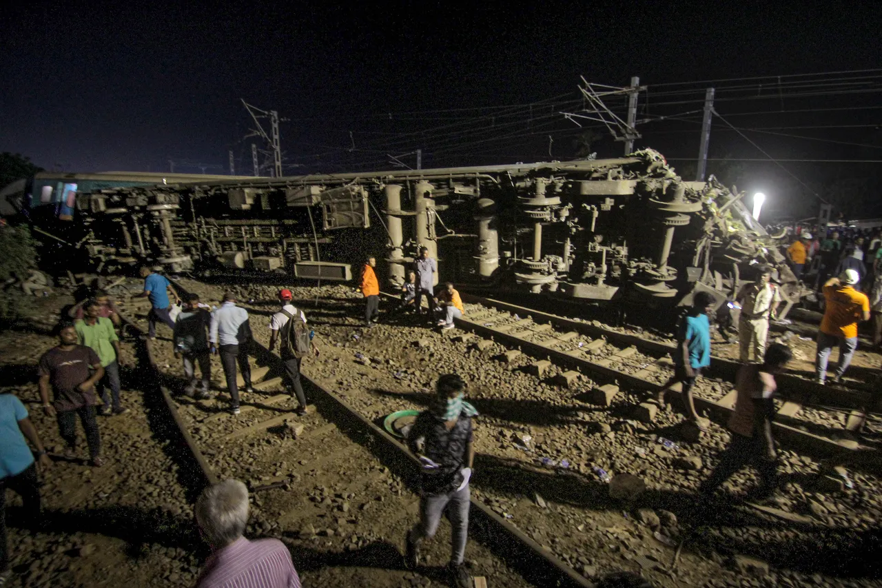 Mangled coaches of train after an accident involving Coromandel Express, Bengaluru-Howrah Express and a goods train