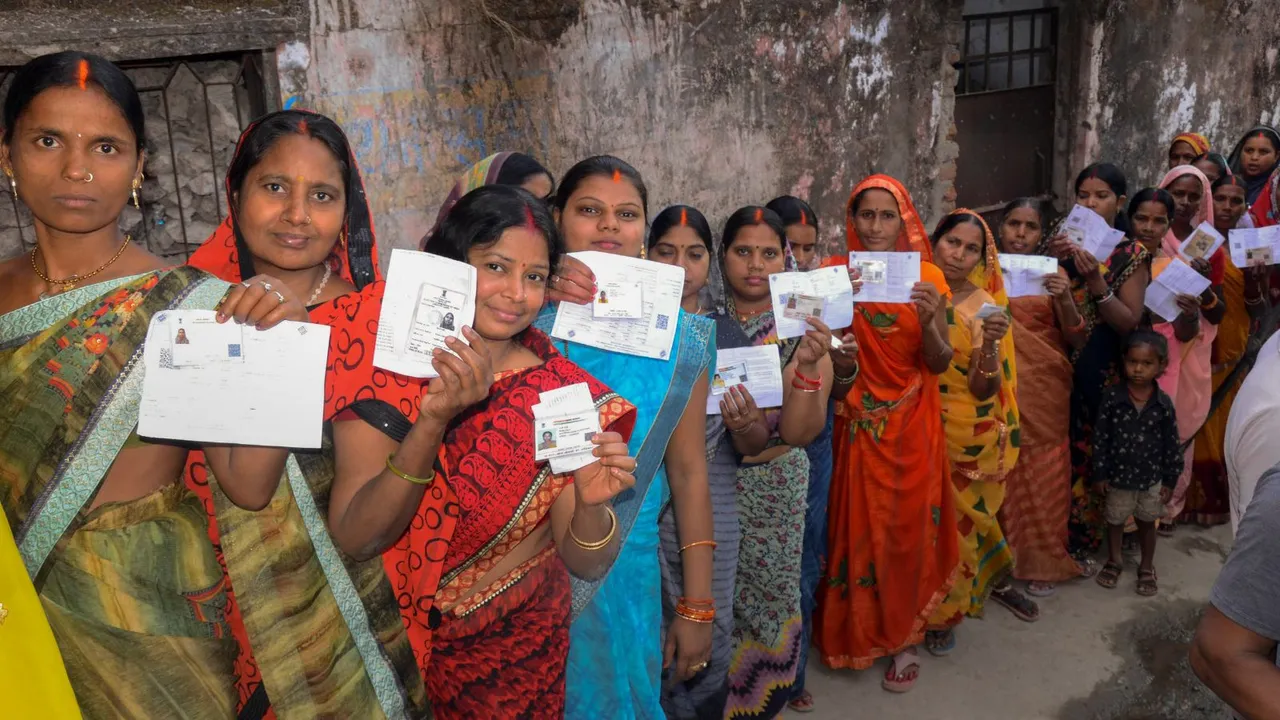 Voters wait to cast their votes for Lok Sabha elections, in Gaya, Bihar, Friday, April 19, 2024