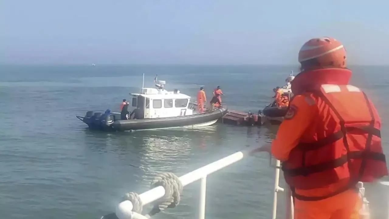 Taiwanese Coast Guard staff surrounding an overturned Chinese speed boat near the Kinmen Islands.