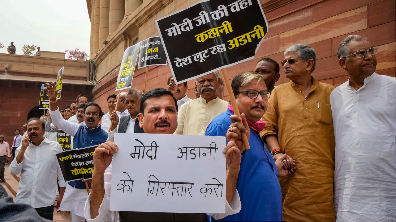 AAP MP Sanjay Singh, RJD MP Manoj Jha, JD (U) MP Lalan Singh and fellow opposition MPs form a human chain to protest over the Adani issue, at Parliament House complex