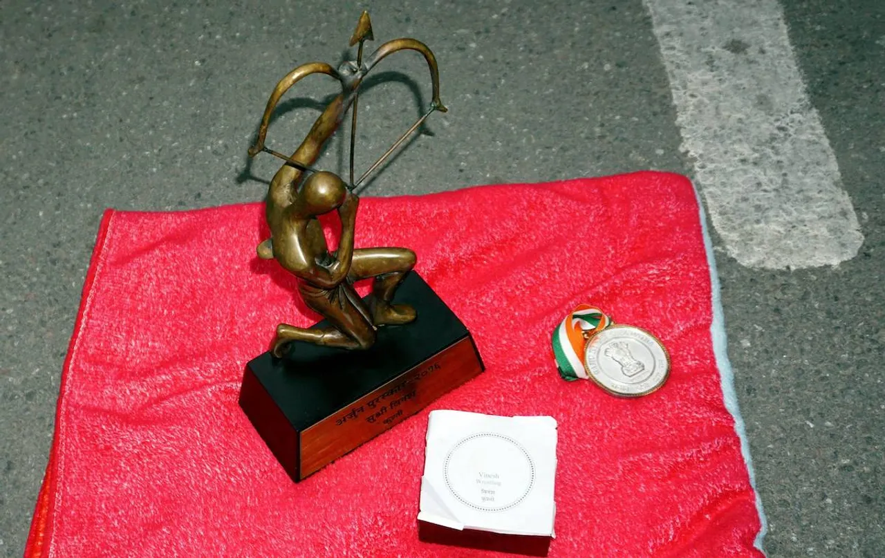 Arjuna and Khel Ratna Awards of wrestler Vinesh Phogat, left by her on a pavement near the prime minister's office as a mark of protest, in New Delhi, Saturday, Dec. 30, 2023.