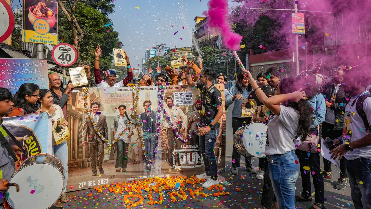 Bollywood actor Shah Rukh Khan's fans celebrate before the screening of the first show of the film 'Dunki' outside a cinema hall, in Kolkata