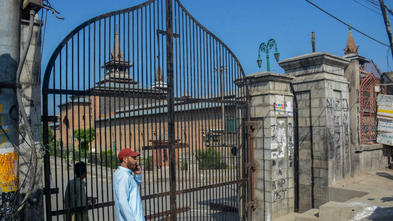 A man outside the locked gate of Jamia Masjid after authorites disallowed offering Eid al-Adha 'namaz' to maintain law and order, in Srinagar, Monday, June 17, 2024.