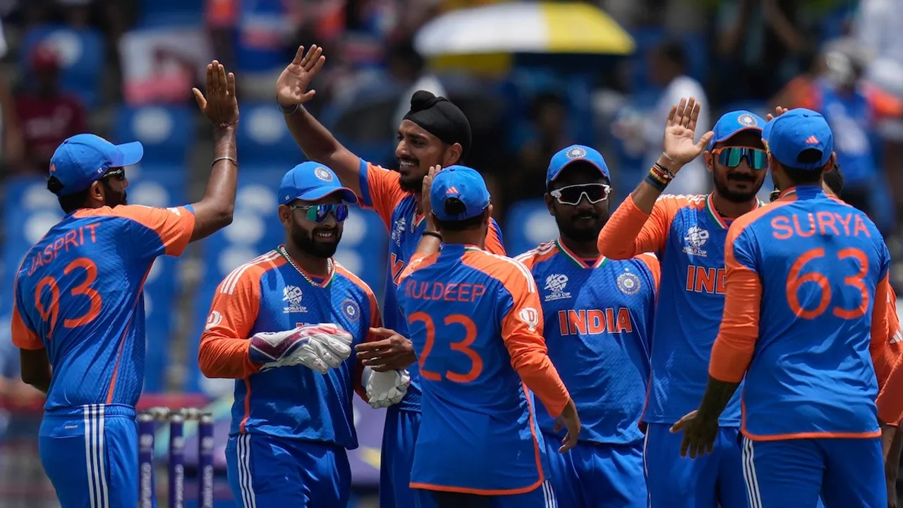 Players of India celebrate the dismissal of Australia's David Warner during an ICC Men's T20 World Cup cricket match at Darren Sammy National Cricket Stadium in Gros Islet, Saint Lucia, Monday, June 24, 2024.