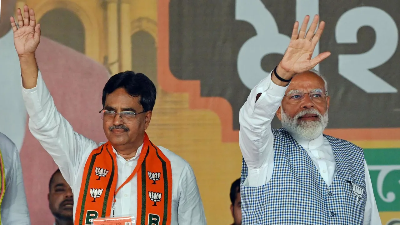 Prime Minister Narendra Modi and Tripura Chief Minister Manik Saha wave at supporters during a public rally ahead of Lok Sabha elections, in Agartala, Wednesday, April 17, 2024